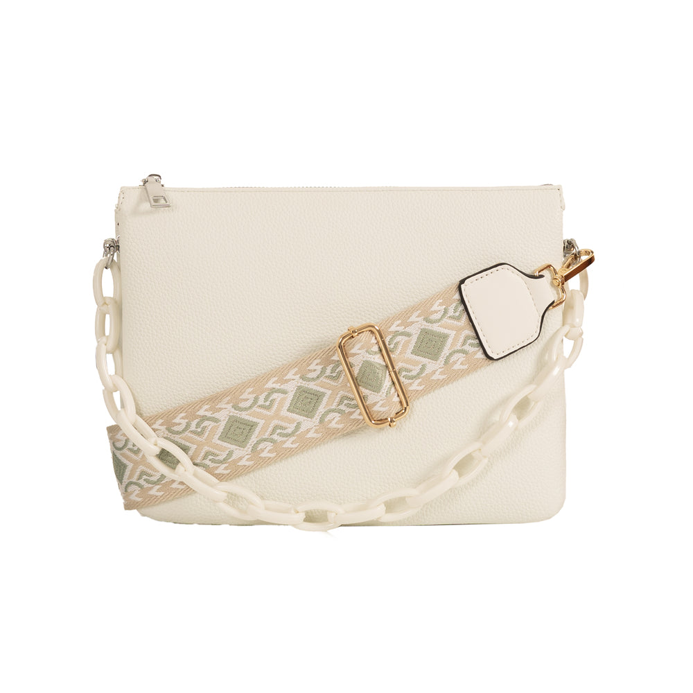 Back of white leather crossbody bag against white background with contrast cream and green strap