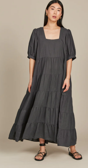 Dark hair lady in a grey dress