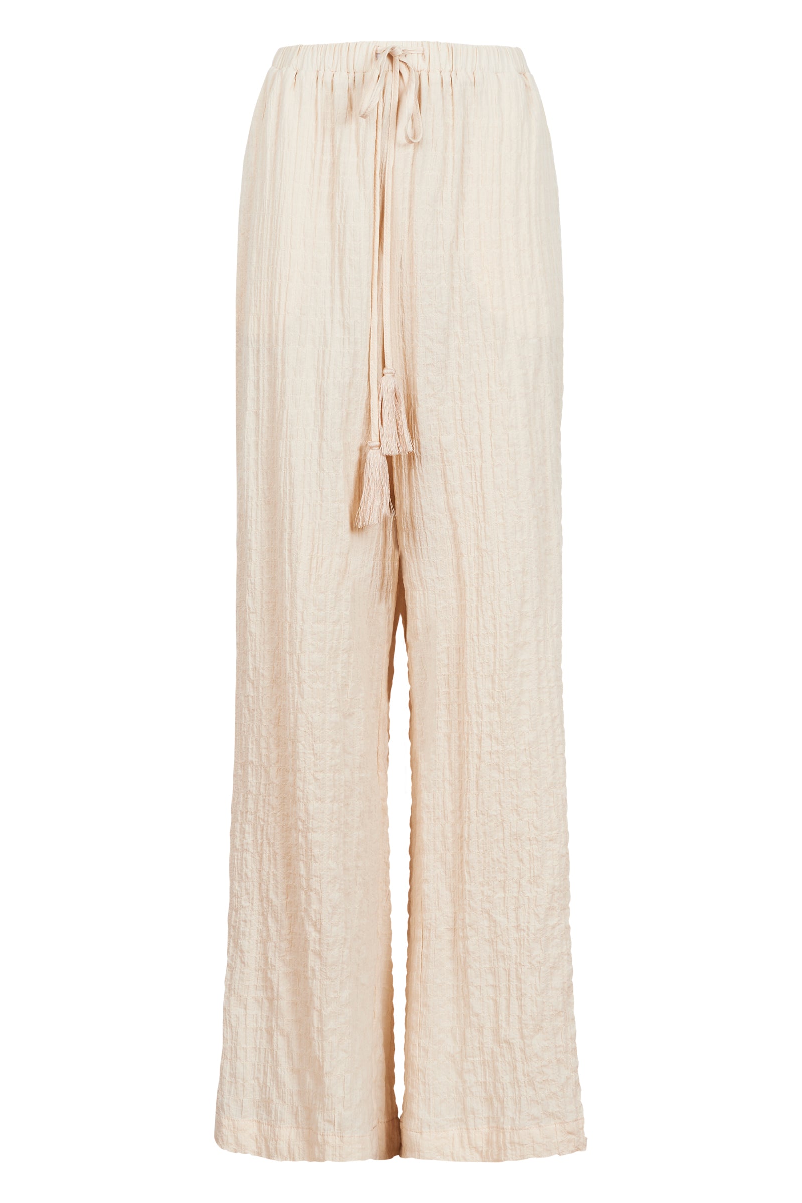 Model in cream cotton and spandex relaxed fit pants with drawstring and white tank