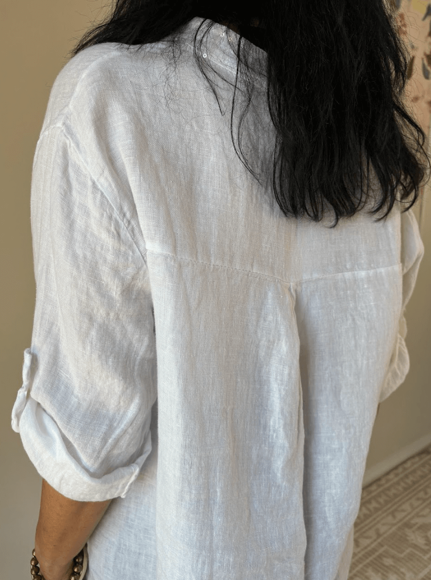 Back of white linen shirt on a lady with black hair