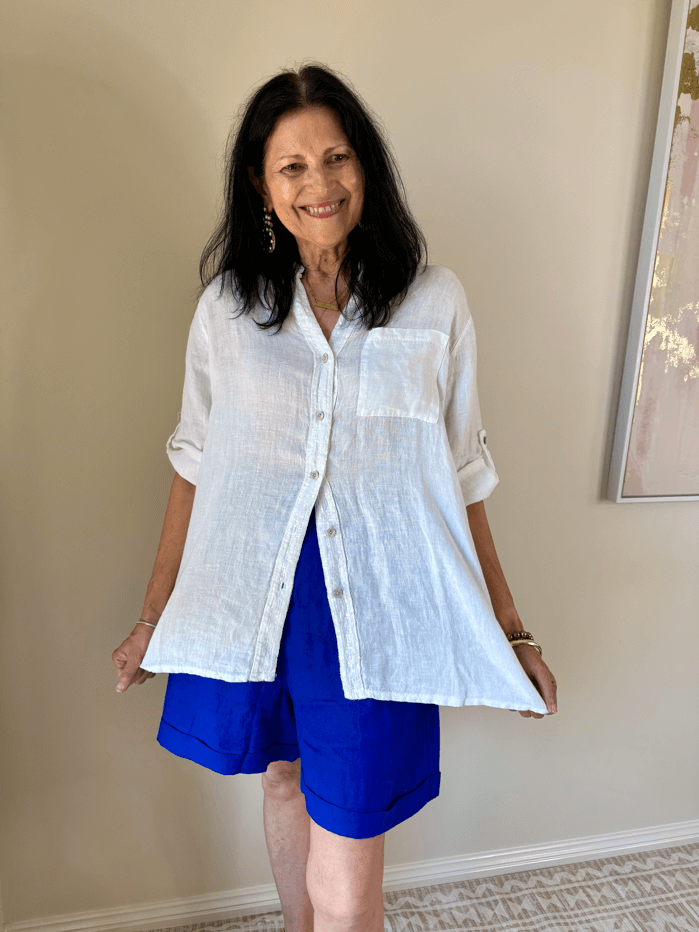 Lady smiling holding her white shirt open