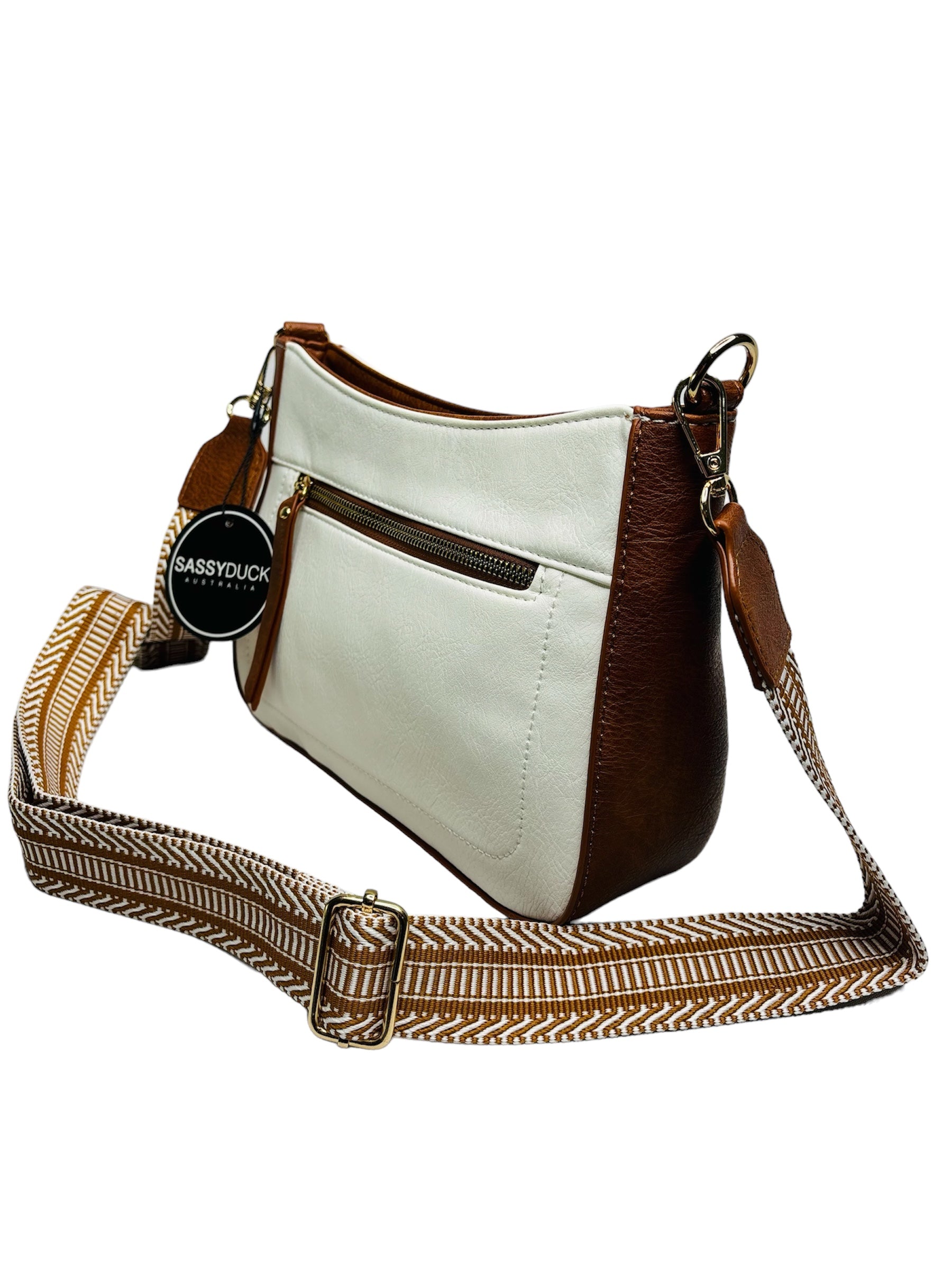 A stylish white and tan leather crossbody bag featuring a comfortable strap for easy carrying with a white background