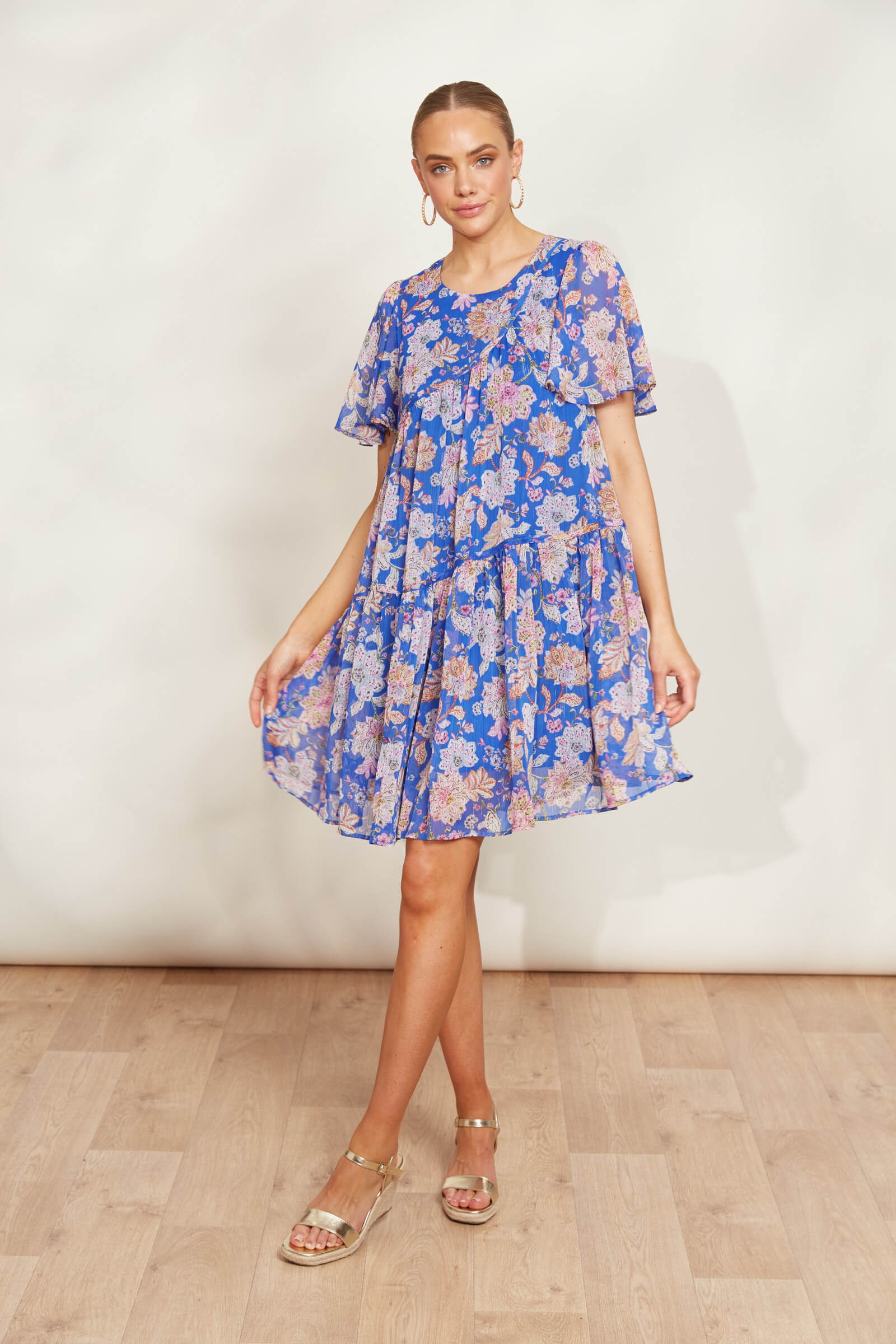 model posing in a blue lurex sparkle knee length dress