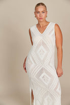 woman in a white dress with a cream background