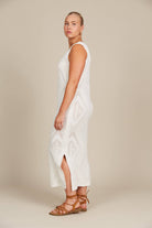woman in a white dress with a cream background