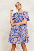 model posing in a blue lurex sparkle knee length dress